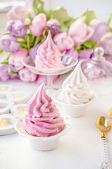 Delicate pink apple marshmallow, made by hand against the backdrop of beautiful tulips.