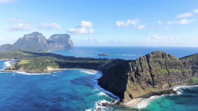 Aerial 4k drone footage of Lord Howe Island, a pacific subtropical island in the Tasman Sea, belonging to Australia. Malabar Hill & Ned's Beach in foreground, Mt Lidgbird & Mt Gower in background.