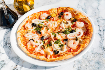 seafood pizza on the marble table