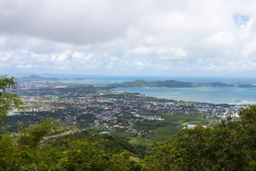 Fototapeta na wymiar Phuket city scape from high hill ground, can see both town and the beach with cloudy sky
