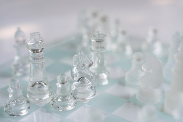 Chess board game made of glass, business competitive concept