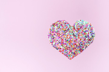 Confetti hearts on pink background. Copy space, top view. Valentine's Day concept.