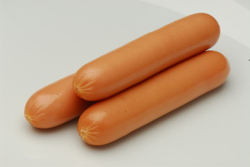 Three frankfurter on an isolated gray background