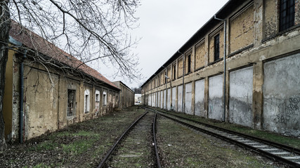 Fototapeta na wymiar old unused railway line between two huts