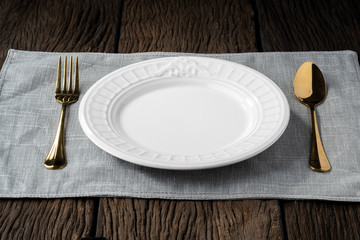 plate fork spoon on wood background clear and without depth of field