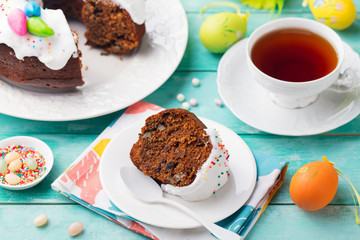 Easter cake on a white plate with colorful eggs. Blue wooden background.