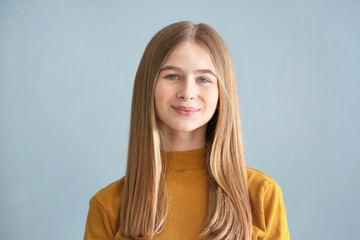 Fototapeta premium Portrait of cute teenage girl on color background
