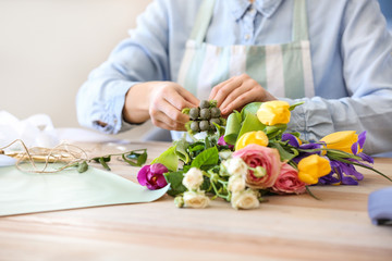 Florist making beautiful bouquet in shop