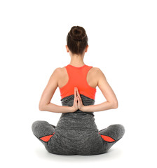Sporty woman practicing yoga on white background