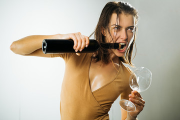 She likes wine. Pretty woman opening wine bottle with teeth. Sensual wine addict holding wineglass. Adorable girl getting wine cork out of bottle without corkscrew - obrazy, fototapety, plakaty