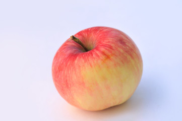Ripe red apple on gray isolated background