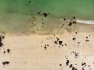 Aerial view. Sea water and sandy shoreline