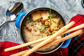 Beef stroganoff with mashed potatoes in a pot. top view, stone background