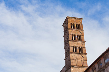 Fototapeta na wymiar Tower against blue, cloudy sky