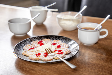 table with fresh waffle on a black plate with wooden background