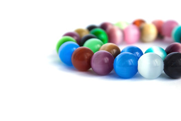 Cat's eye quartz necklace and bracelet, selective focus on white background isolated. Colourful precious stones.