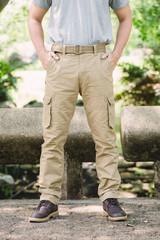 Model wearing yellow brown  color cargo pants or cargo trousers