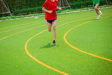 Fototapeta premium young sport girl running on sport field