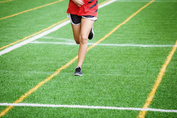 young sport girl running on sport field