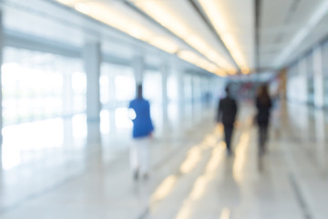 Blurred background of businesspeople walking in the corridor of an business center
