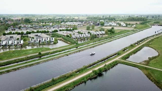 Aerial footage of the yacht or boat passing on the canal in Holland