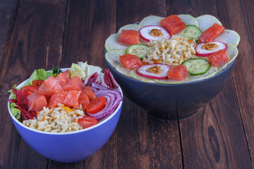 Raw fish, rice and fresh vegetables on a wooden background. Healthy eating concept