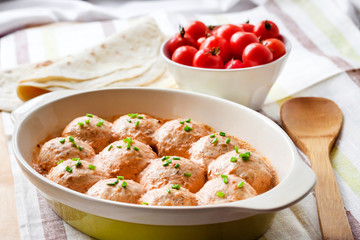 Chacken meatballs baked in creamy tomato sauce