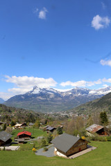 Fototapeta na wymiar Route de Saint-Nicolas de Véroce. Vue sur Saint-Gervais-les-Bains. Alpes Françaises. / Road of Saint-Nicolas de Véroce. View of Saint-Gervais-les-Bains. French Alps.