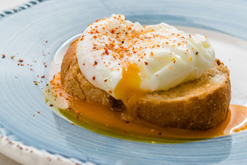 Poached Egg with Spices on Toast Bread for Breakfast.