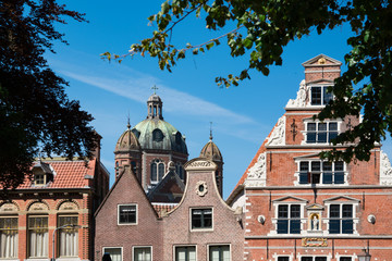 Obraz premium stepped gable of typical dutch house, Koepelkerk Church, Hoorn, The Netherlands, against blue sky