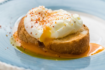 Poached Egg with Spices on Toast Bread for Breakfast.