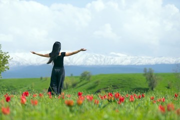 girl in flower field with white dress in tulip field 