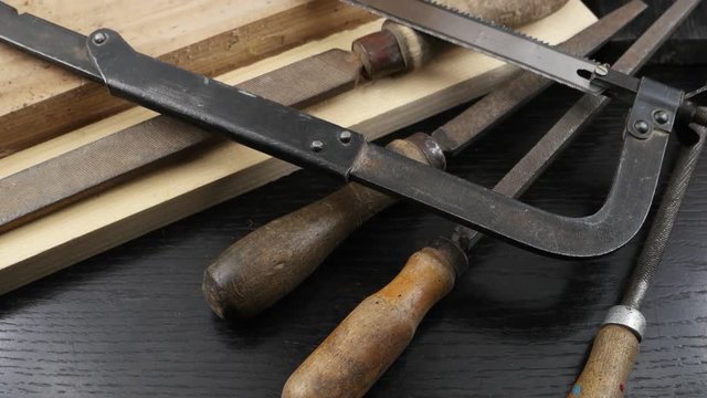 Carpentry hand tools. Circular saw blades, handsaw, a set of files and  vise  on the background of lumber