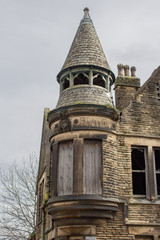 The once imposing turret above a police station in Bradford, Yorkshire, is now boarded up and the empty building stands neglected although its former glory is easy to see