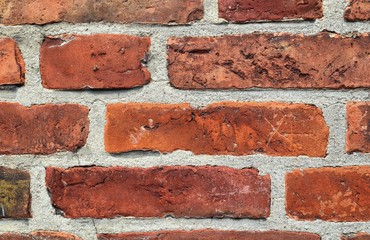 Detailed close up of colorful aged and weathered brickwall in high resolution