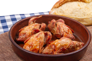 Close-up photo of roasted quail and white bread. White copy space background.