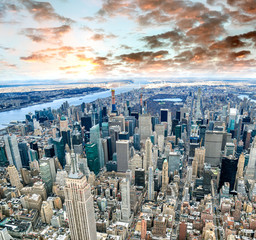 Aerial view of Manhattan skyline from the sky on a cloudy day, New York City at sunset