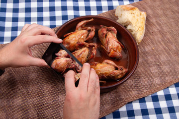 Man takes a picture of food by smartphone