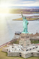 Statue of Liberty on Liberty Island and Ferry Boat with tourists, New York City