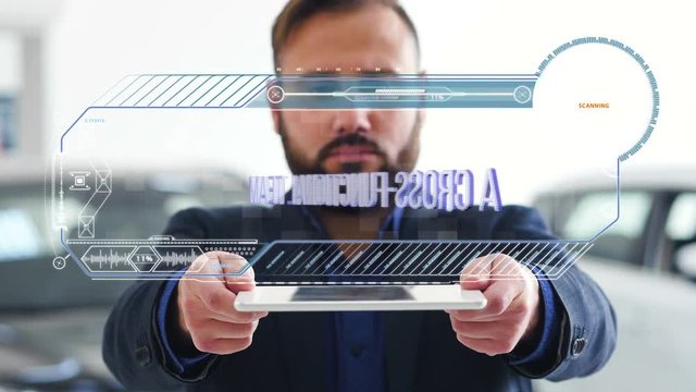 Businessman holds a tablet with HUD futuristic elements. Hologram with an inscription - A cross-functional team
