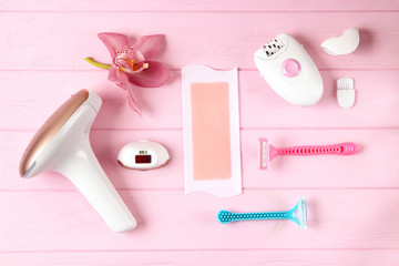 A set of different hair removal products on a wooden table. Removal of unwanted body hair at home.