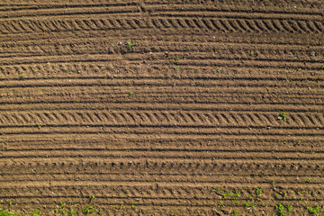 tractor tracks on brown soil