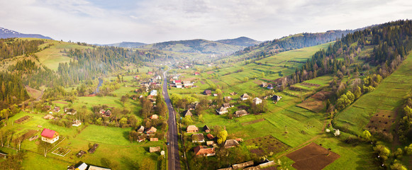 Road in mountain village. Aerial Panorama of Carpathian valley.