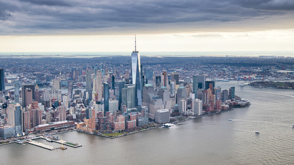 Fototapeta na wymiar New York City from helicopter point of view. Downtown Manhattan, Jersey City and Hudson River on a cloudy day