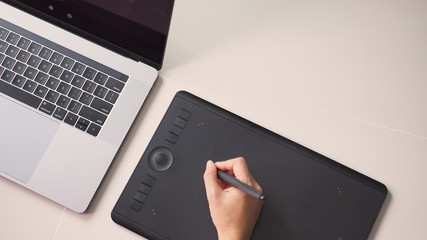 Hand and laptop computer. and mouse pad.On white background.