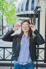 Fototapeta premium portrait of a stylish girl of 21 years in sunglasses