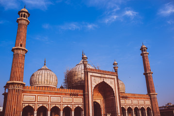 Main mosque in the city under construction. The main dome under construction. pillars, domes, speakers, gates with beautiful, serene, cloudy, morning sky int the background.