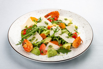 Salad with arugula, shrimp and avocado, parmesan cheese