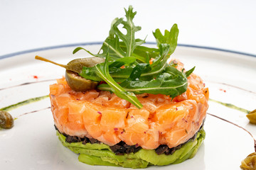 Tartar with salmon with arugula and avocado mousse