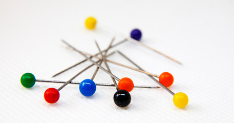 colorful pins on white background